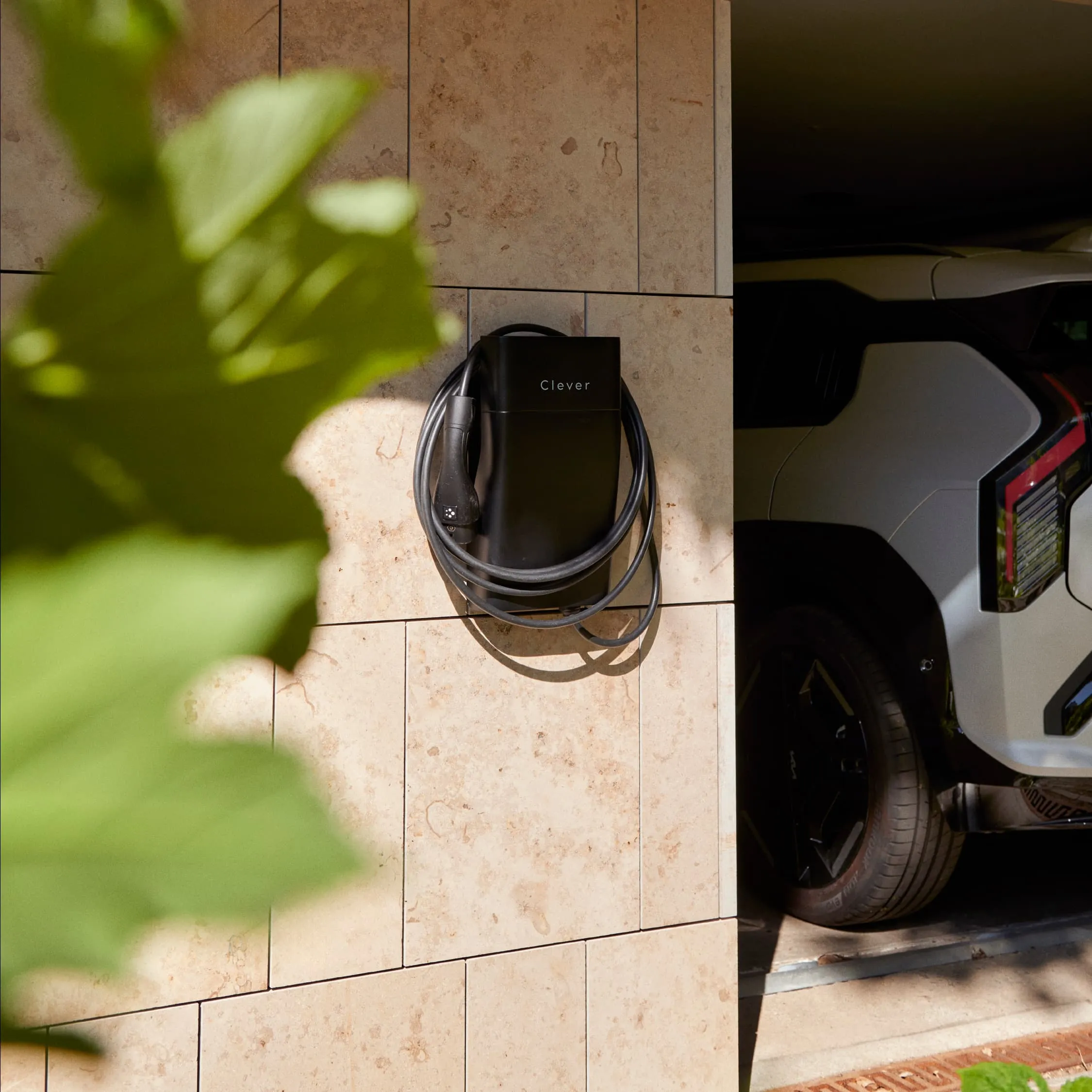 Sort ladeboks hænger ved carport ved siden af bil